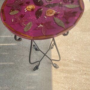 Majenta table  with seeds, seed pods and leaves in uniform pattern